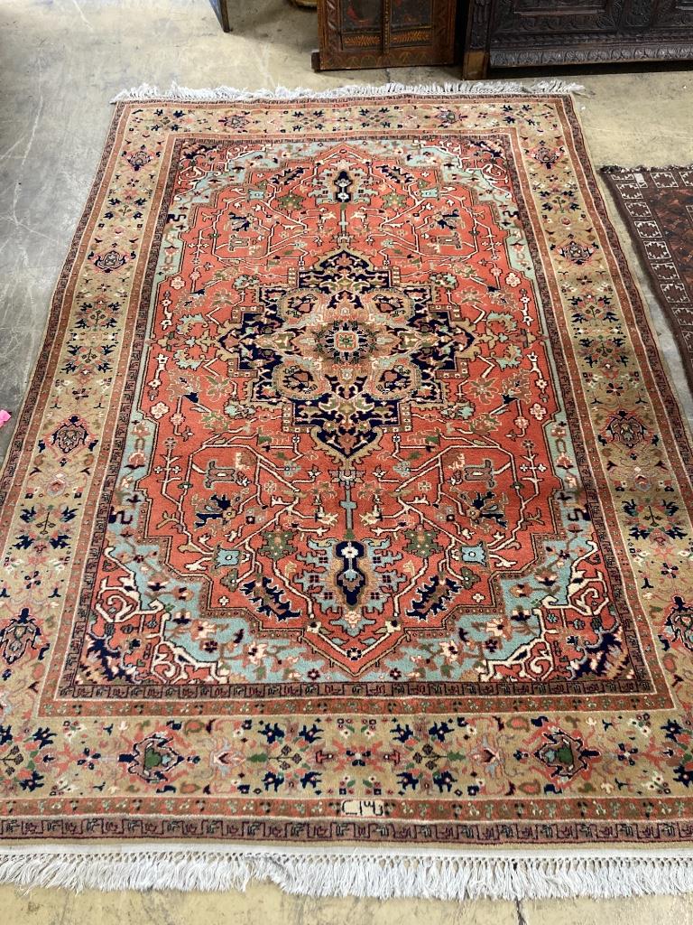 An Indian Heriz style red ground carpet, 270 x 108cm